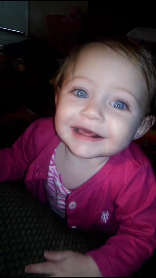 Luna smiling because she distracted mommy from her homework.